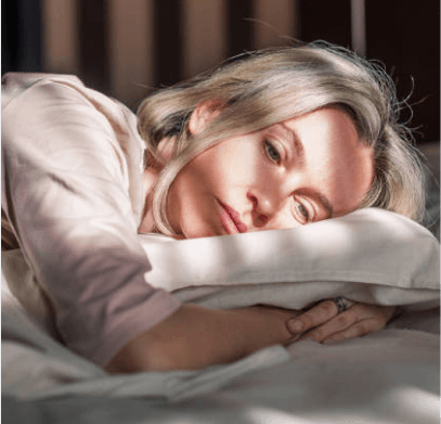 Woman lying on a pillow looking forlorn