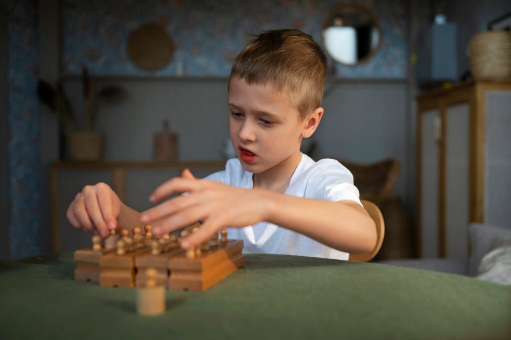 Young boy playing with wooden toys on a table